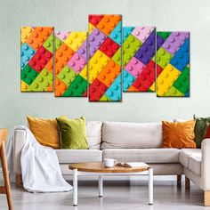 a living room with white couches and colorful legos on the wall above them