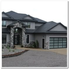 a large gray house with two car garages