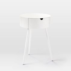 a white table with two legs and a drawer on the top that has a black hole in it