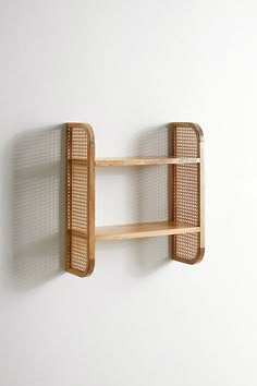 a wooden shelf mounted to the side of a wall