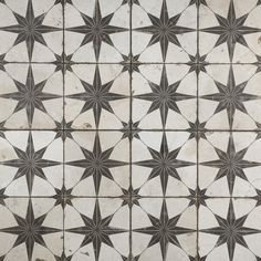 an old tiled floor with star designs on the top, and bottom part of it