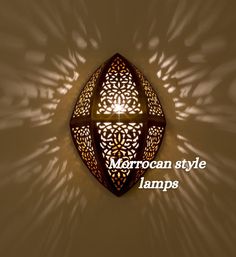 a light that is on the side of a wall with words above it reading moroccan style lamps