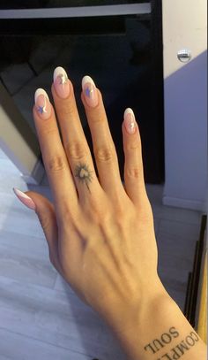 a woman's hand with a small tattoo on it