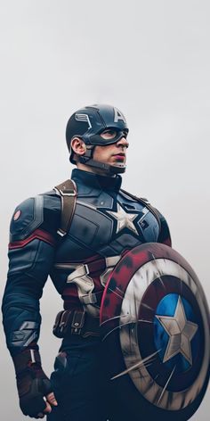 a man dressed as captain america holding a shield