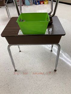 a green container sitting on top of a desk in a room filled with other items