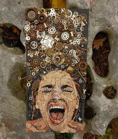 there is a piece of art made out of buttons and other things on the wall