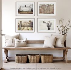 a wooden bench with four pictures on the wall above it and three baskets underneath it