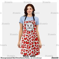 a woman wearing an apron and smiling at the camera with her hands in her pockets