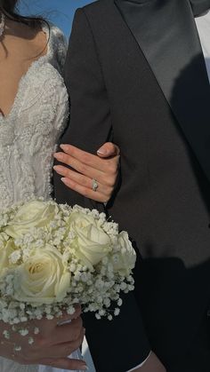 the bride and groom are holding each other's hands