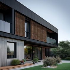 an exterior view of a modern home with wood siding