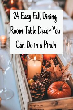 a wooden box filled with pine cones and candles on top of a dining room table