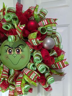 a christmas wreath with an ornament on it