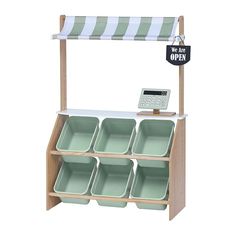 a shelf with trays and a sign that says it's okay to open