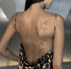 a woman with a flower tattoo on her back