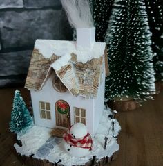 a small white house with snow on the roof