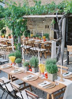 an outdoor dining area with tables, chairs and place settings for dinner guests to eat