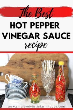 the best hot pepper vinegar sauce recipe on a cutting board with wine glasses and plates