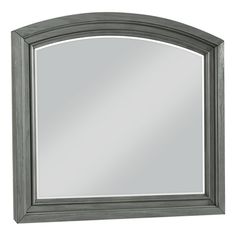 a gray framed mirror on a white wall