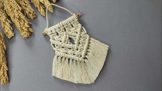 a piece of woven material hanging from a string