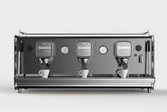 an espresso machine with three cups on the front and two controls on the back