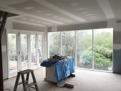 the room is being remodeled and ready to be used as a living area with sliding glass doors