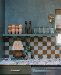 a kitchen counter with vases and other items on it