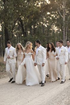 the bride and grooms are walking down the road