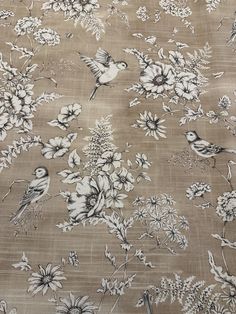 a floral pattern with birds and flowers on a tan background, made up of fabric