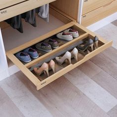 there are several pairs of shoes in the drawer on the floor next to each other