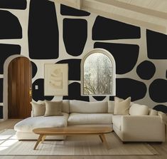 a living room with black and white wallpaper