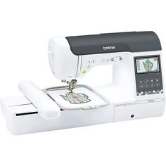 the brother sewing machine is white and has an embroidered design on it's side