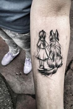 a person with a tattoo on their leg holding the hand of another person's arm