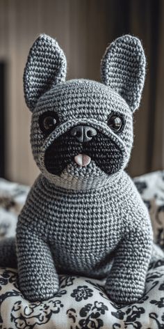 a crocheted dog sitting on top of a bed