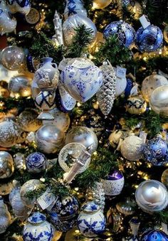 a christmas tree decorated with blue and white ornaments