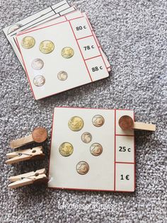 counting coins and clothes pins on the floor next to two matching cards with clothes pins