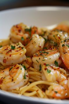 a white bowl filled with pasta and shrimp