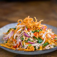 a salad with shredded carrots and onions on a plate