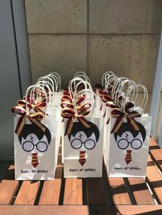 some harry potter bags are sitting on a wooden table with ribbons and bows around them