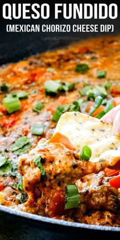 a hand dipping tortilla into a skillet filled with mexican chorizo cheese dip