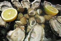 oysters and lemon wedges on ice with water