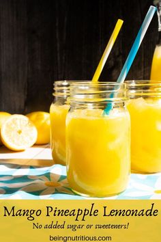 three mason jars filled with lemonade sitting on top of a table