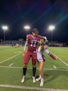 a couple of people that are standing on a field