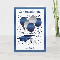 congratulations card with balloons and confetti on the table next to a vase filled with flowers