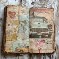 an open book with old cars and hearts on the pages, sitting on top of a wooden table