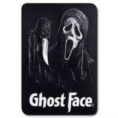 a black mouse pad with a ghost face on it