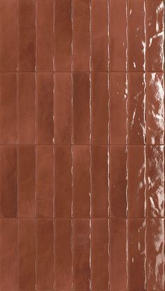 a brown tile wall with vertical lines on it