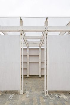 an empty room with white walls and open shelvings on the floor in front of it