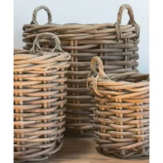 three wicker baskets sitting on top of a wooden floor