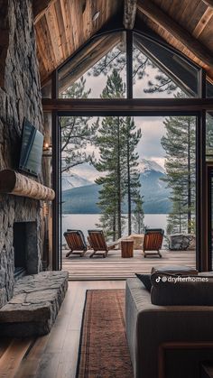 a living room filled with furniture and a large window overlooking the water's edge