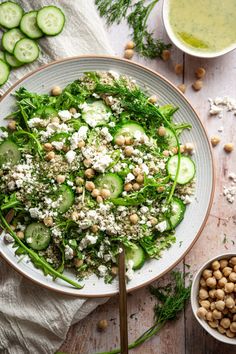 a salad with cucumbers, chickpeas and feta cheese in a bowl